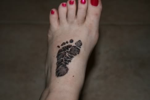 We got Anthony's Foot prints from the hospital tattooed on the top of our