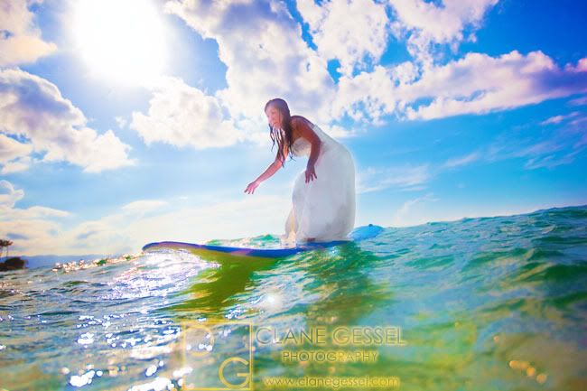 surfing with the bride in her wedding dress in hawaii hawaii wedding 